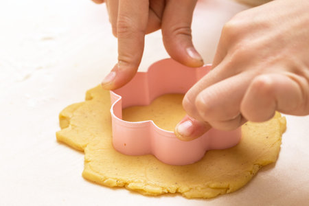 little girl makes a cookie in the kitchen