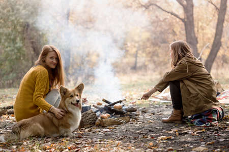 Happy family - mom and daughter on picnic in the autumn forestの写真素材