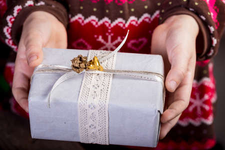 girl holding presents in handsの写真素材