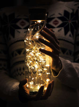 Christmas garland in the hands of a girlの写真素材