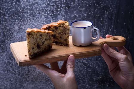 girl hands  holding pear pie on the cutting board の写真素材