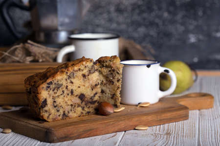 pear pie and tea with milk on a wooden tableの写真素材