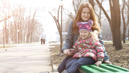 happy family - smiling mother with daughter outdoorの写真素材