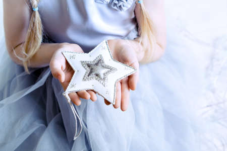 Christmas - children's hands girl holding a star
の写真素材