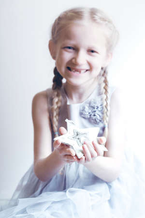 Christmas - smiling girl holding a starの写真素材