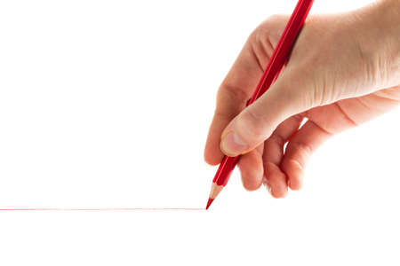 hand with the red pencil on a white backgroundの写真素材
