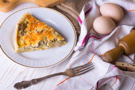 French onion pie on a plate, near fork, eggs, onion
の写真素材