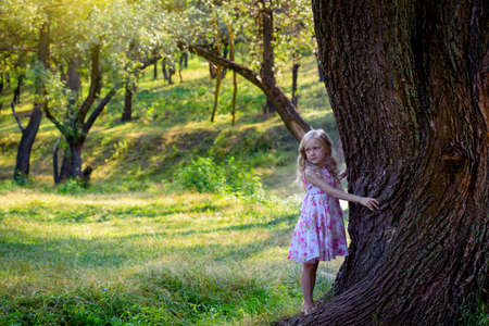 portrait smiling little girl in the forest, summerの写真素材