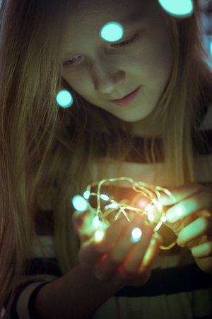 Christmas garland in the hands of a girl