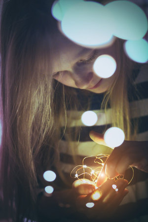 Christmas garland in the hands of a girlの写真素材