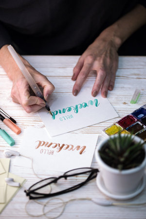 girl makes the inscription watercolor -  hello weekendの写真素材