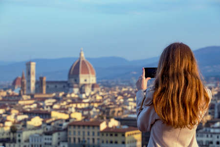 girl making a photo shoot of Florence with the smartphone の写真素材