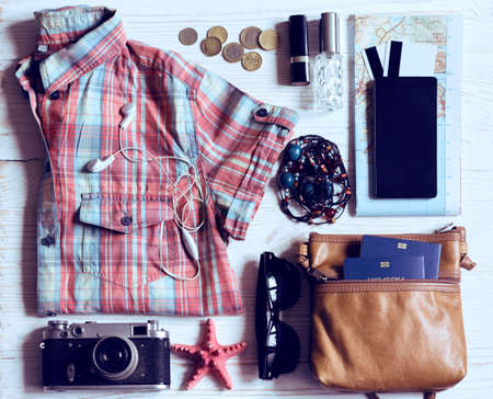 background - what to take for a trip. passport, phone, documents,  map, camera, money, sunglasses, credit cards, clothesの写真素材