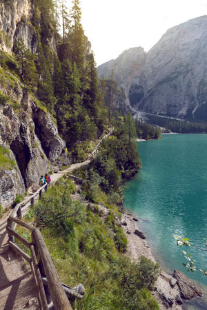 family. mother and her daughter walking around the Braies lake, Dolomites Italy