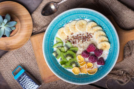 healthy lifestyle. healthy food - oatmeal with banana, kiwi and raspberriesの写真素材