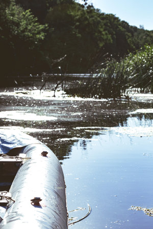 summer and active sport. rafting boat on the river bank