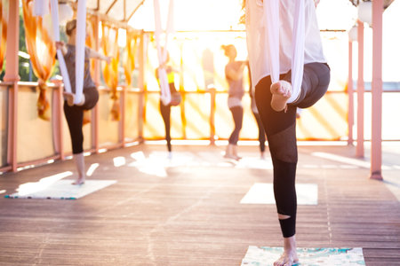 Healthy and fly Yoga Concept. happy smiling girl in a fly yoga class