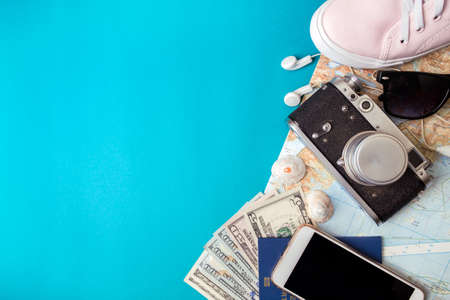 background for a trip - watches, sneakers, map, dollars, glasses, camera, headphones, passportの写真素材
