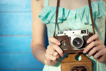 Girl with retro camera. Vintage.の写真素材