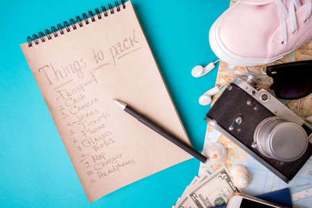 background for a planning trip - watches, sneakers, map, dollars, glasses, camera, headphones, passportの写真素材