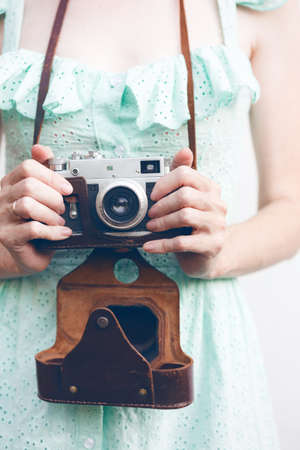 Girl with retro camera. Vintage.の写真素材