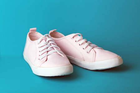 pink sneakers on a blue backgroundの写真素材