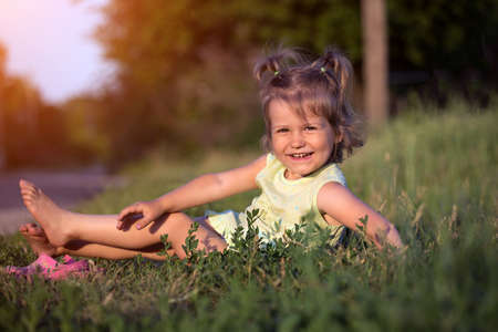 little smiling girl at the gardenの写真素材