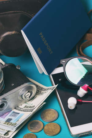 background for a trip - map, glasses, camera, smartphone, passport, dollars, headphonesの写真素材