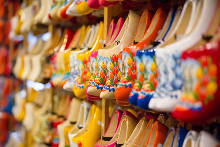 lot of multicolored souvenir Dutch wooden shoes klomp in the shop
