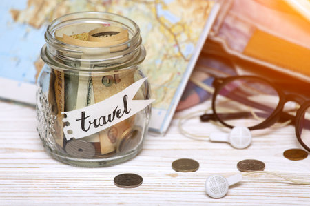wanderlust. adventure concept. background - what to take for a trip - camera, smartphone, jar with...