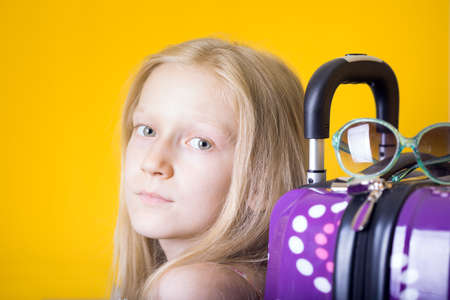 happy weekend. Smiling girl going to trip -  luggage, map, glassesの写真素材
