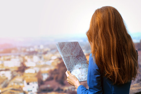 traveler girl looks at the map of walking in Certaldo. Tuscany, Italyの写真素材