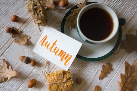 Beautiful autumn background - cup of tea, biscotti, autumn leaves and inscription Sunday