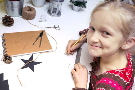 Christmas decorations. little girl made garlands starsの写真素材