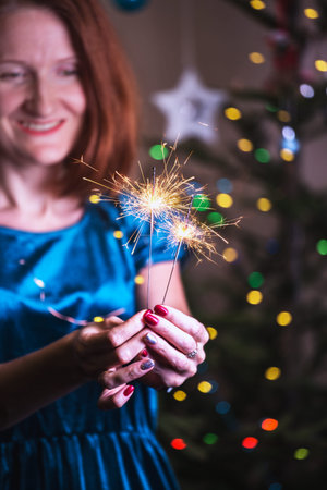 girl holds bengal lights - happy christmas and merry holidays