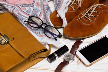 the contents of the female handbag - wallet, keys, phone, lipstick, clock, money, accessoriesの写真素材