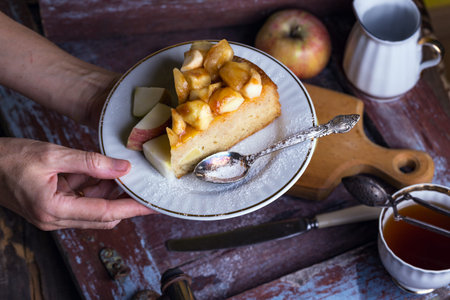 French apple pie on a plate on a vintage background