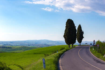empty road and green hill in Tuscany, Italyの写真素材