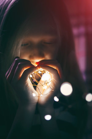 Christmas garland in the hands of a girlの写真素材