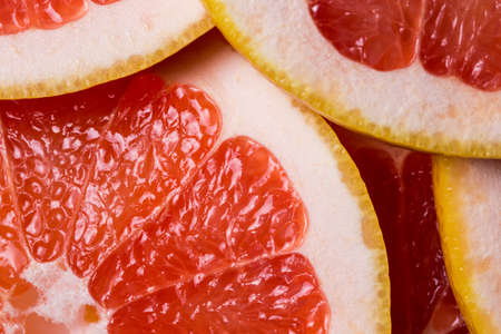 background made with a heap of sliced grapefruitsの写真素材