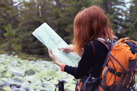 camping trip. girl hiker with a map at the Carpathians mountains. gorgany, Ukraine.