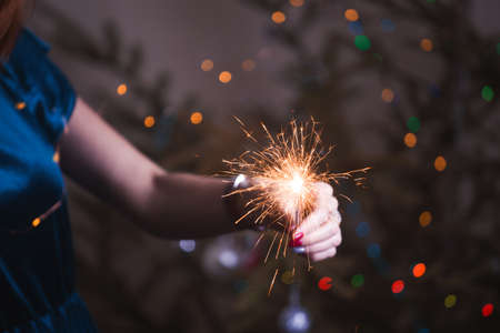 girl holds bengal lights - happy christmas and merry holidaysの写真素材