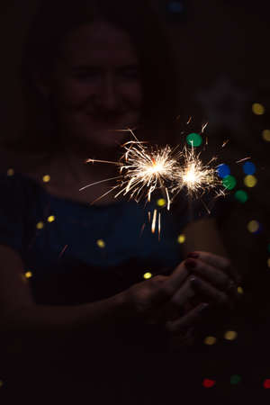 girl holds bengal lights - happy christmas and merry holidaysの写真素材