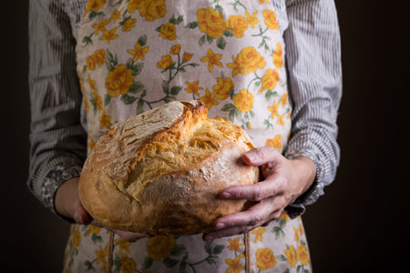 girl baker holding fresh white bread