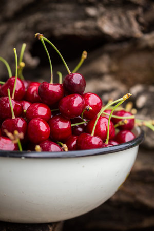 Cherry in a bowl  on the wood background