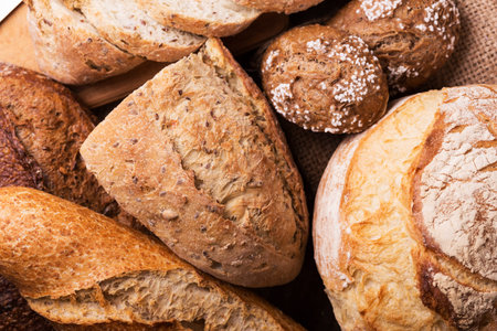 different fresh bread and buns on the wooden table