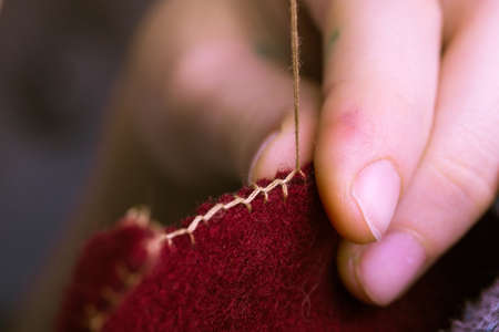 creation. little girl sews toy made of feltの写真素材