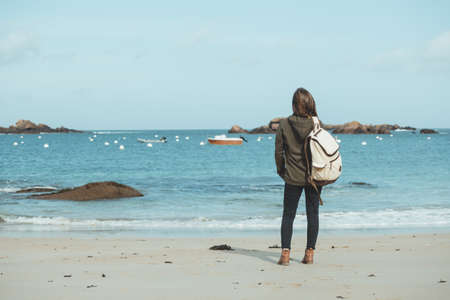 pretty girl walking on the shore of the sea at  the Tregastel, normandy. Franceの写真素材