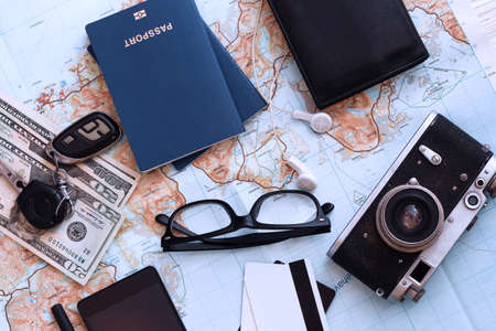 background - what to take for a trip. passport, documents, car keys, map, camera, money, sunglasses, credit cards, accessoriesの写真素材