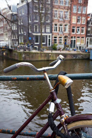 retro bike standing on a street of amsterdam, netherlandsの写真素材